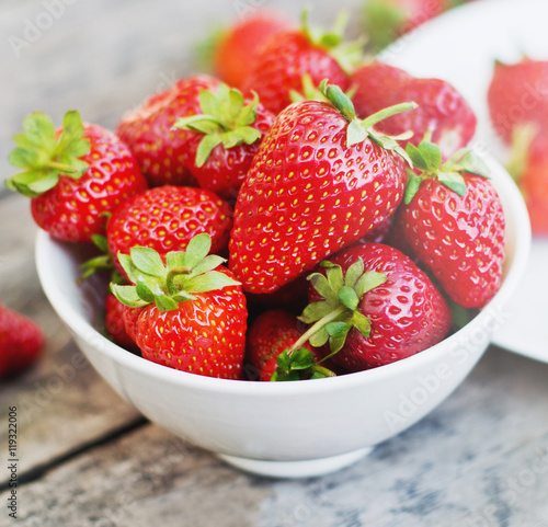 Ripe red strawberries on wooden table