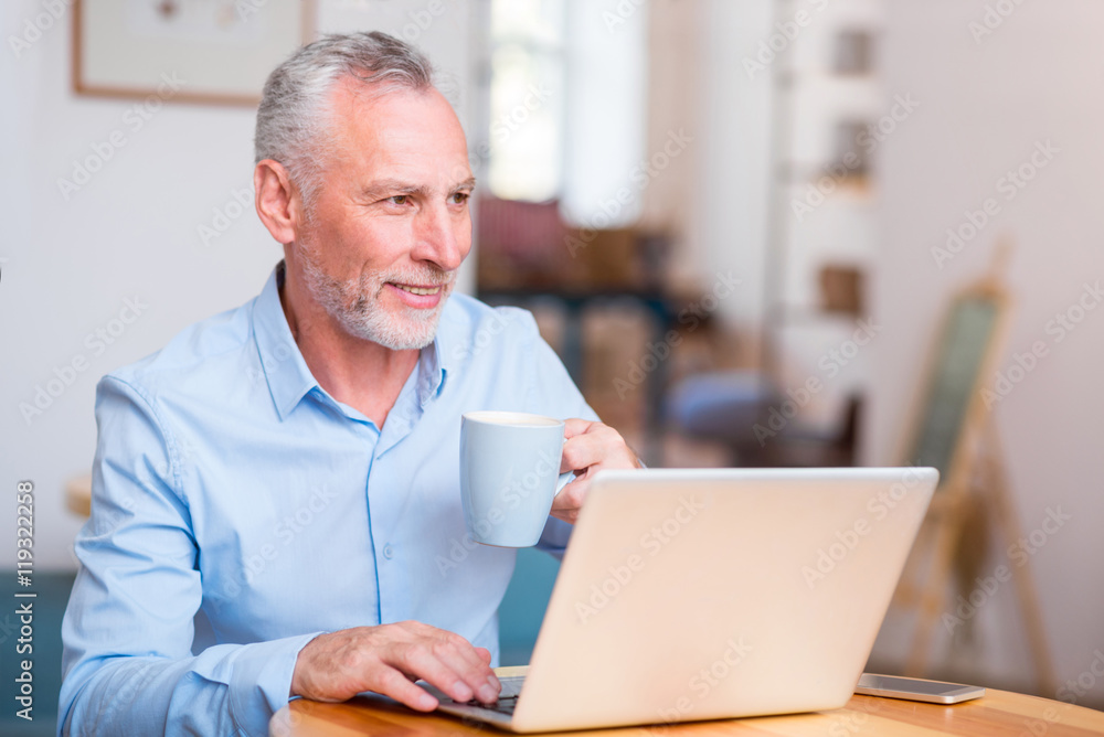 Cheerful man sitting at the table Cheerful man sitting at the table