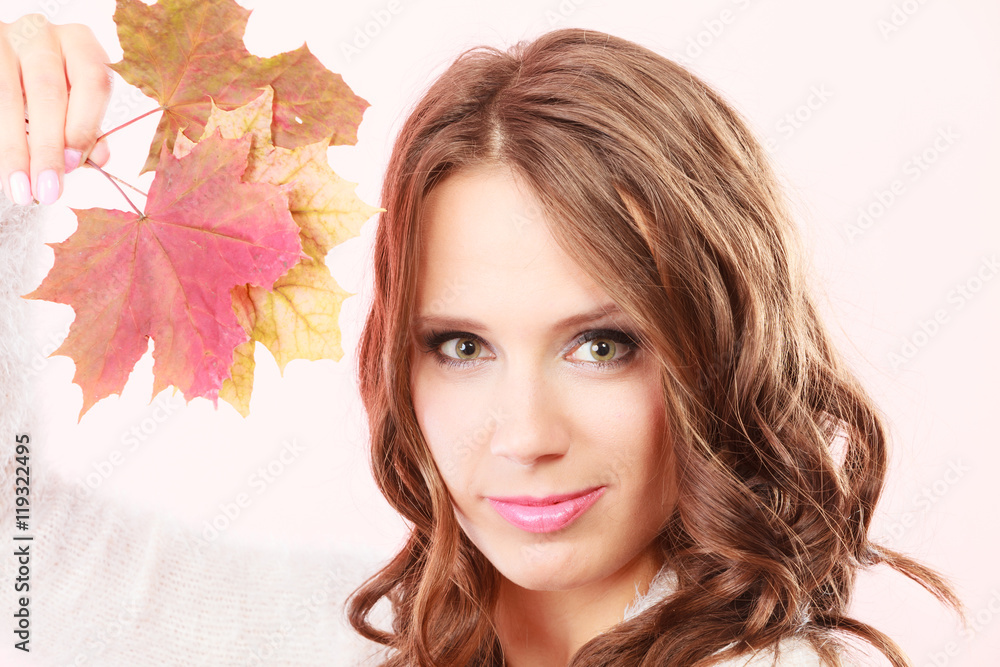 Fototapeta premium Lovely autumnal girl with maple leaves in hand