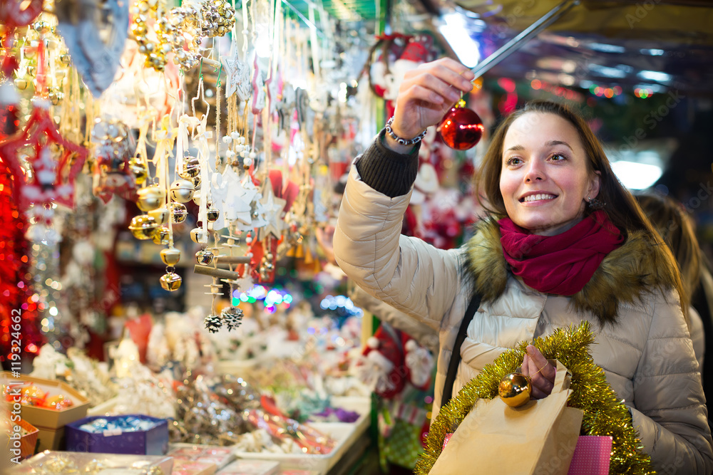 Woman at Christmas fair in evening.