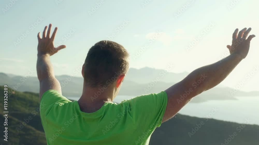 Man standing on the hill and holding hands up, steadycam shot
Man standing on the hill and holding hands up, steadycam shot