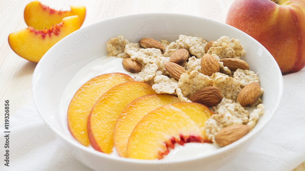 Whole grain cereal with fresh peach fruit, yogurt and almond in Whole grain cereal with fresh peach fruit, yogurt and almond in