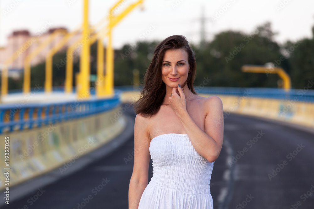 Beautiful brunette woman in white dress on the street Beautiful brunette woman in white dress on the street