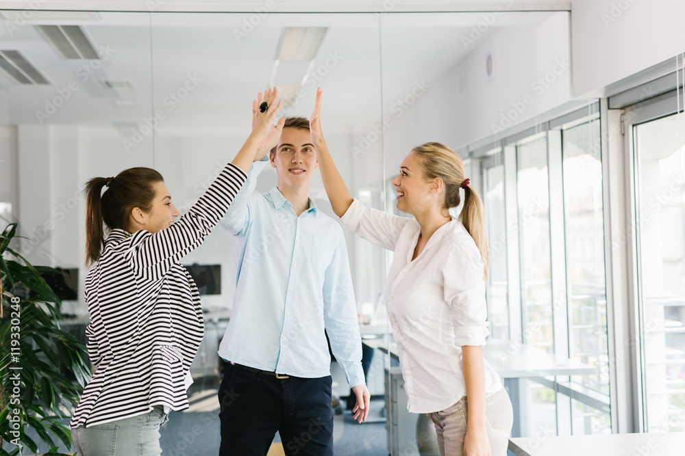 Obraz premium Group of business professionals giving each other a high-five