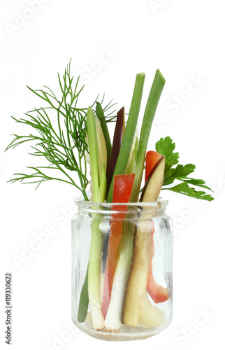 Sliced vegetables in a glass on a white isolated background