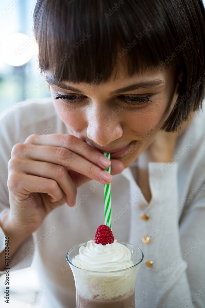 Woman drinking milkshake with a straw