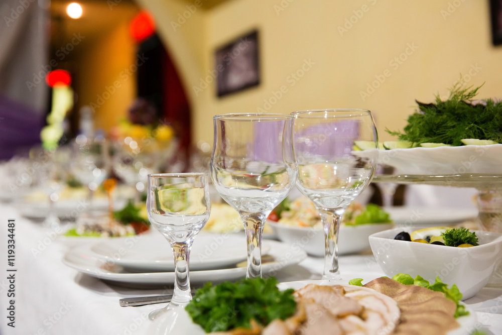 Table in a restaurant with glasses, napkins and cutlery