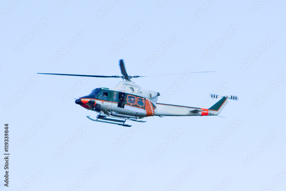 White-orange helicopter is flying White-orange helicopter is flying
