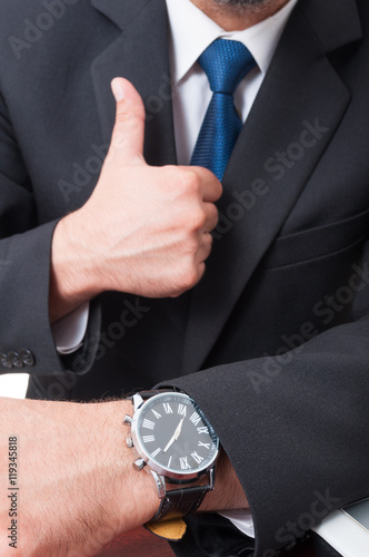 Successful broker doing like sign in close-up