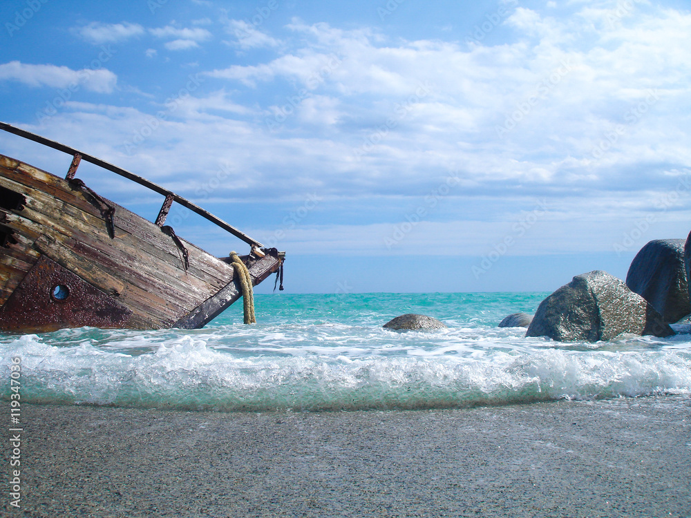 Shipwreck on a beach with blue sky