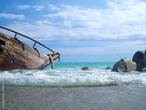 Shipwreck on a beach with blue sky