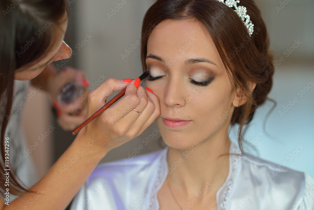 Stylist makes makeup bride on the wedding day Stylist makes makeup bride on the wedding day
