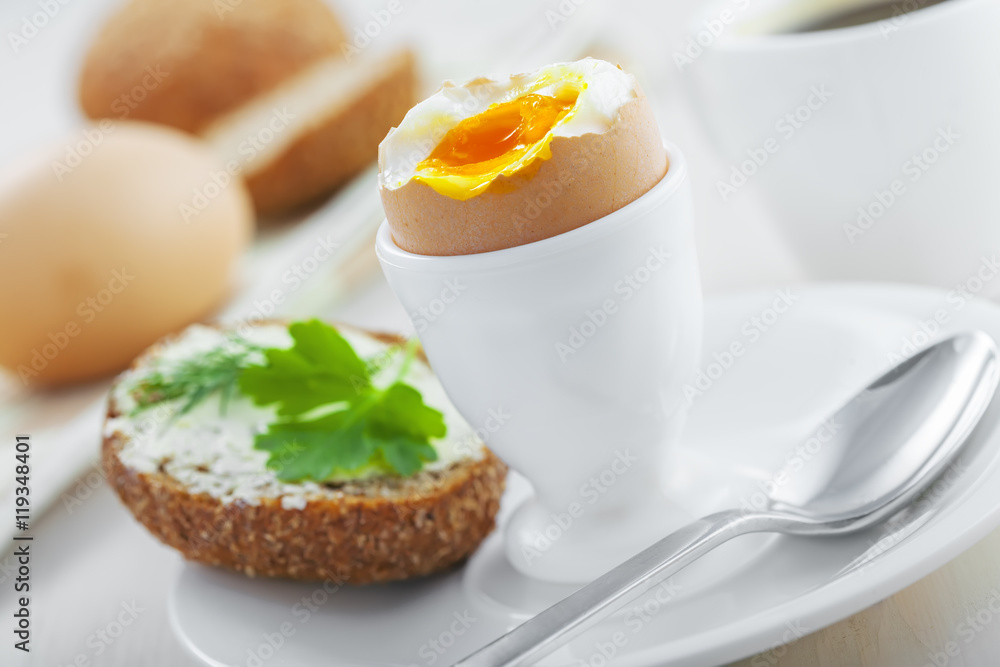 Breakfast with perfect soft boiled egg, sandwich with cheese and coffee on a table. Traditional homemade food. Breakfast with perfect soft boiled egg, sandwich with cheese and coffee on a table. Traditional homemade food.