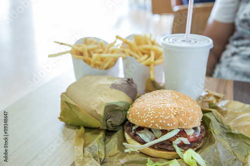 Hamburger meal served with french fries and soda in a restaurant