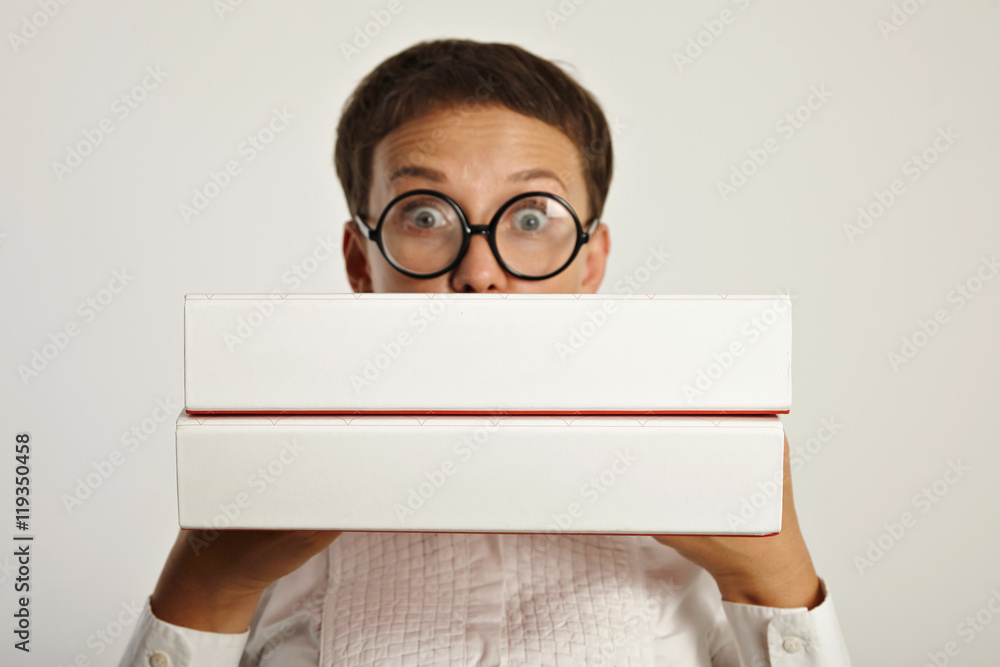 Surprised woman student holds two big folders with educational plan for new year in university Focus on folders Surprised woman student holds two big folders with educational plan for new year in university Focus on folders