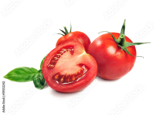 Fresh tomatoes and tomato slice with basil leaves, isolated on white.