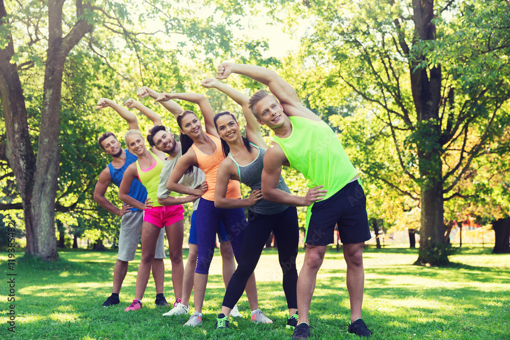 Fototapeta premium group of friends or sportsmen exercising outdoors
