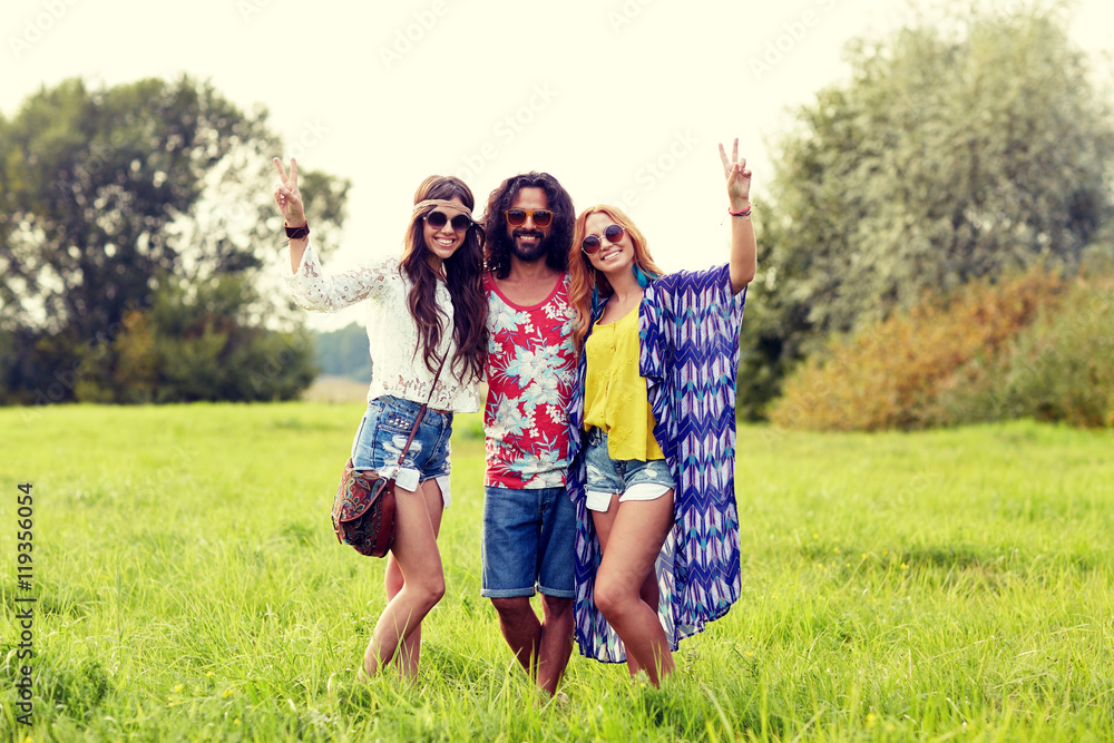 happy young hippie friends showing peace outdoors happy young hippie friends showing peace outdoors