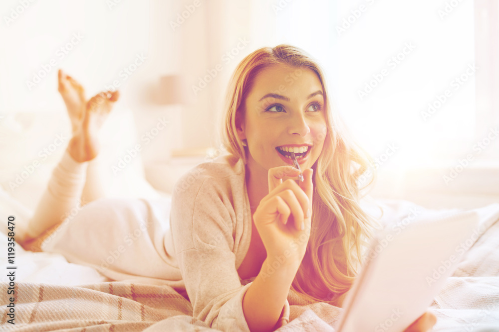 happy young woman with notebook in bed at home happy young woman with notebook in bed at home