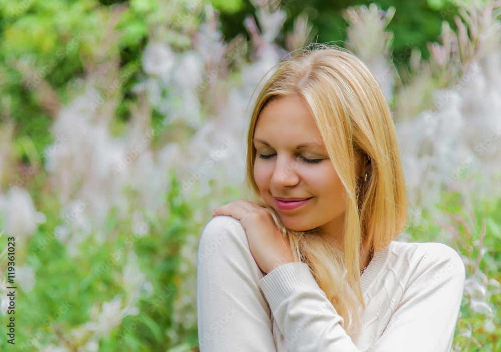 Young, charming, beautiful woman in gentle atmosphere feels the touch of an angel on her shoulder. Outdoor portrait. Young, charming, beautiful woman in gentle atmosphere feels the touch of an angel on her shoulder. Outdoor portrait.