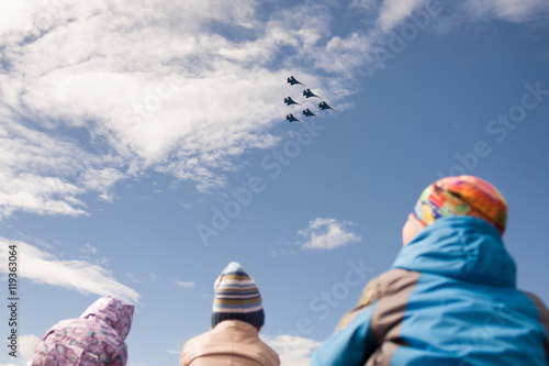 Children look at the group of Sukhoi Su-27 (Flanker) fighter air