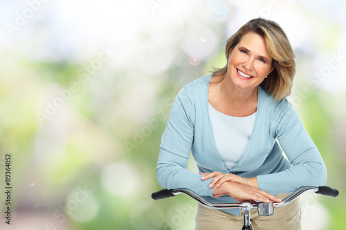 Beautiful elderly woman with bicycle.