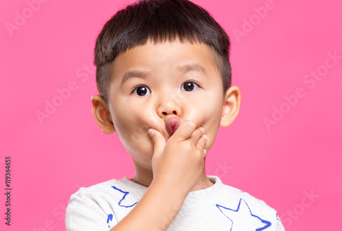 Little boy with hand touch on his cheek