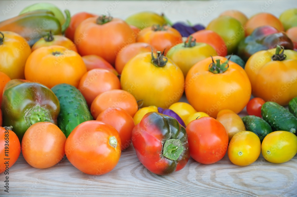 Crop of yellow and red tomatoes, cucumbers, sweet peppers. Food background. Crop of yellow and red tomatoes, cucumbers, sweet peppers. Food background.