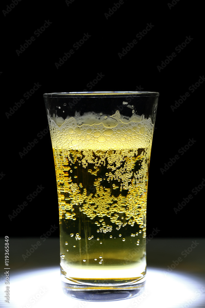 this is Closeup of a glass of fresh foamy beer this is Closeup of a glass of fresh foamy beer