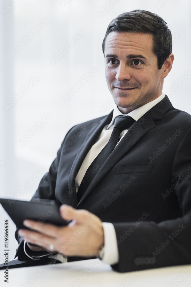 Businessman in office using digital tablet, Stockholm, Sweden Businessman in office using digital tablet, Stockholm, Sweden