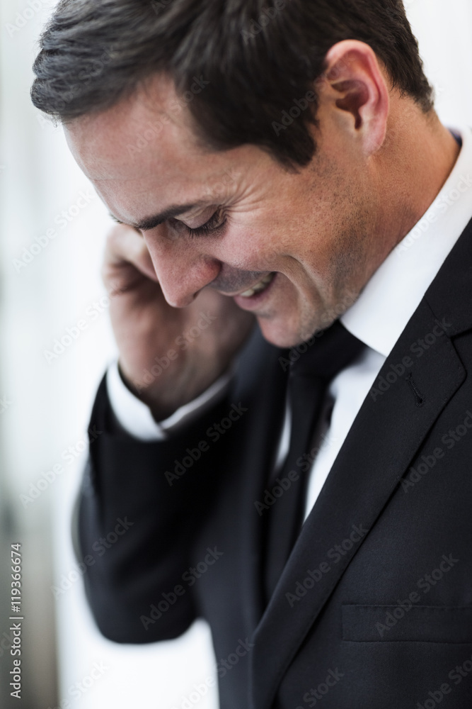 Mid adult businessman talking via cell phone, Stockholm, Sweden Mid adult businessman talking via cell phone, Stockholm, Sweden