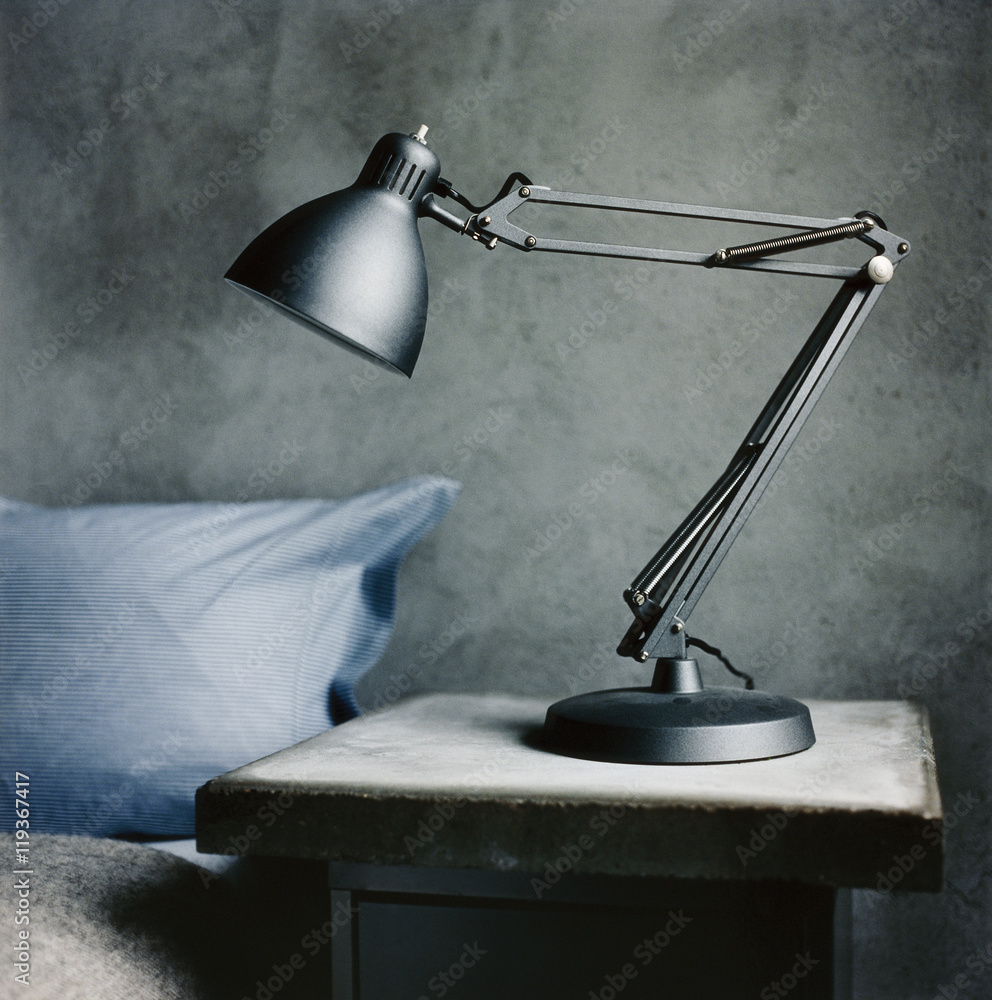 © Johnér - A lamp on a bedside table.