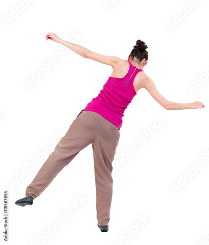 Balancing young woman. or dodge falling woman. dark-skinned girl in a red shirt is balancing on his leg.