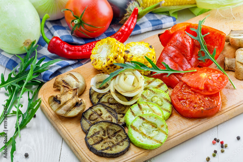 Grilled vegetables: tomato, corn, eggplant, mushroom, bell pepper, marrow and onion. Delicious healthy food and ingredients on a table.