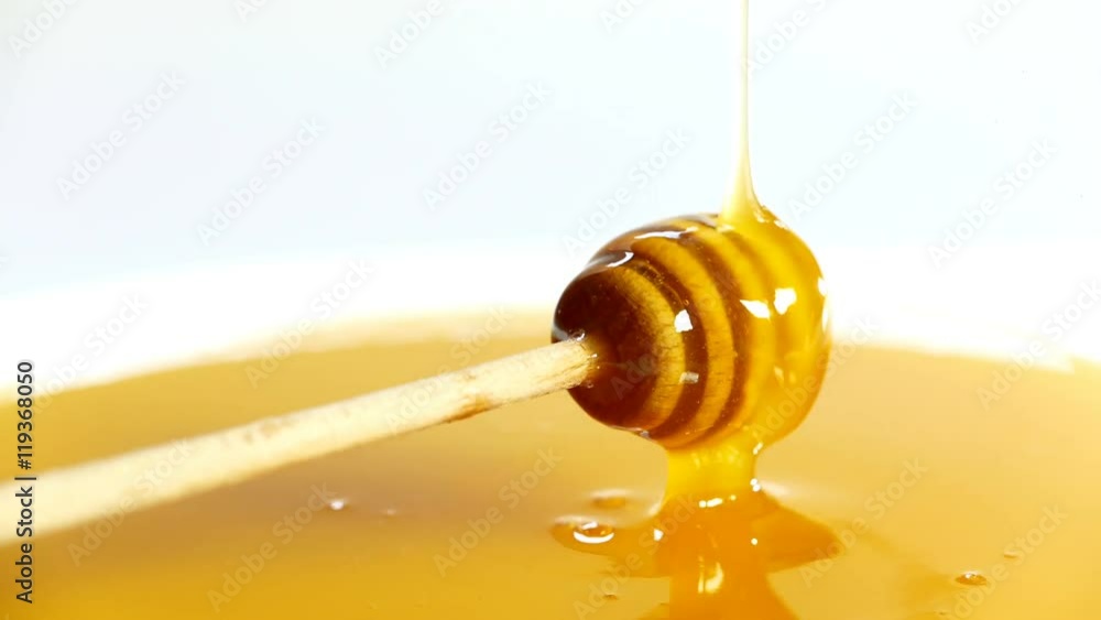 honey dripping in a bowl full of honey,vintage look. honey dripping in a bowl full of honey,vintage look.