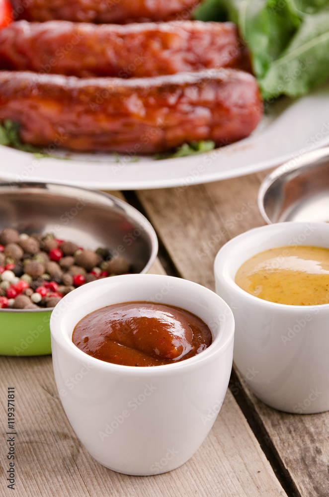 Sausage. Delicious sausages in a plate with ingredients. Salad. Sausage. Delicious sausages in a plate with ingredients. Salad.