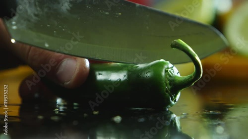 Slicing into a green jalapeno