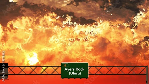 Passing Ayers Rock Australia Highway Sign in the Sunset