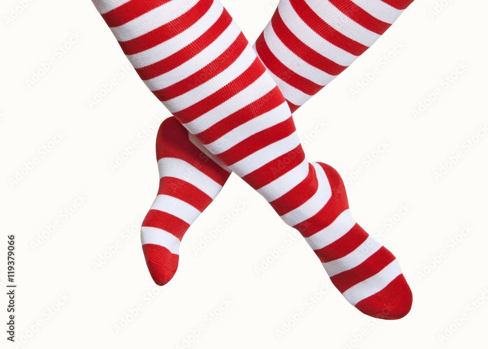 Obraz premium Legs in red and white striped socks isolated on white background