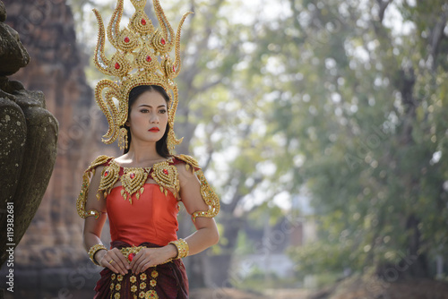 A beautiful woman in dancer apsara costume at stone castle,public place in Thailand photo