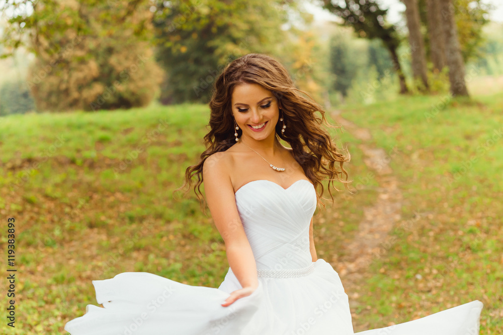 Wind blows bride's hair while she whirls her magnificent dress o Wind blows bride's hair while she whirls her magnificent dress o