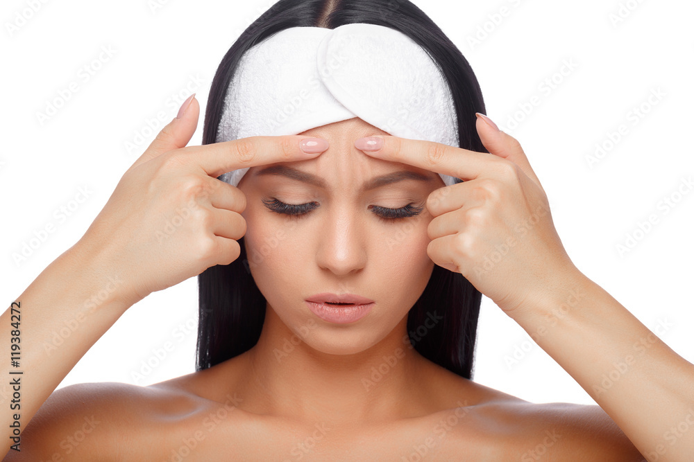 Young woman squeezing her pimple Young woman squeezing her pimple
