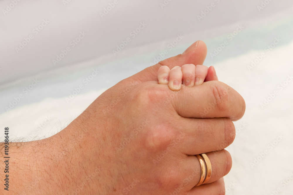 Handle newborn baby in father's hand Handle newborn baby in father's hand