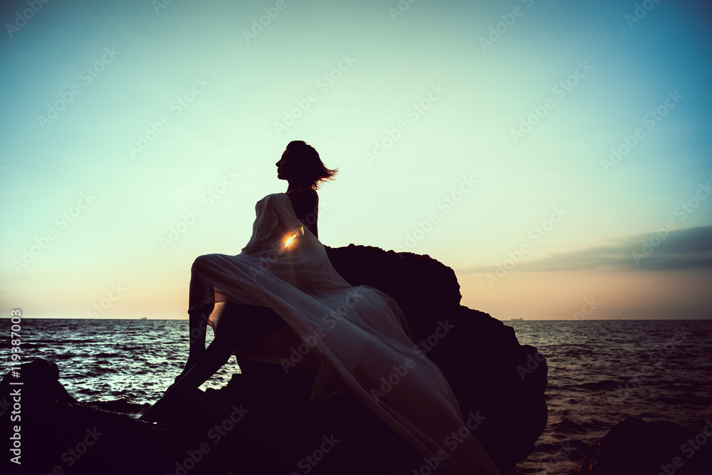 woman in white cloth on the rock