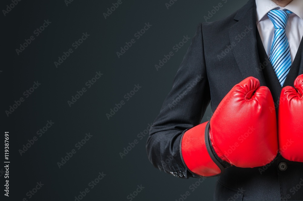 Boxing businessman with red gloves and empty space in background.