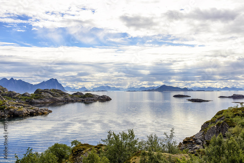 Lofoten coastline near Svolvaer, Norway. Lofoten archipelago is known for a distinctive scenery with dramatic mountains and peaks, open sea and sheltered bays, beaches and untouched lands.