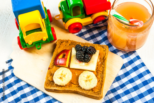 Funny breakfast for kid: a sandwich with fruit machine and peanut butter