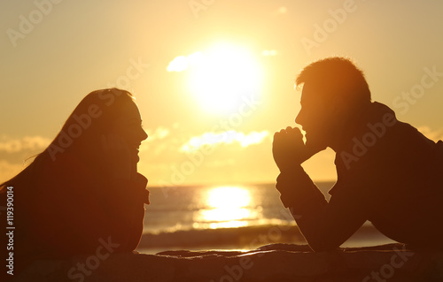 Couple looking each other at sunset