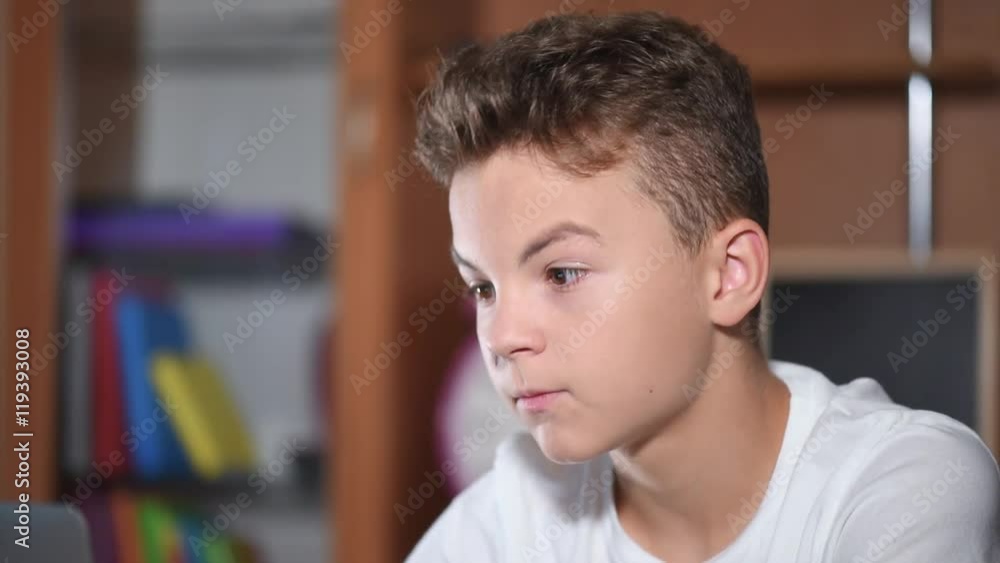 Teen boy working on laptop Teen boy working on laptop