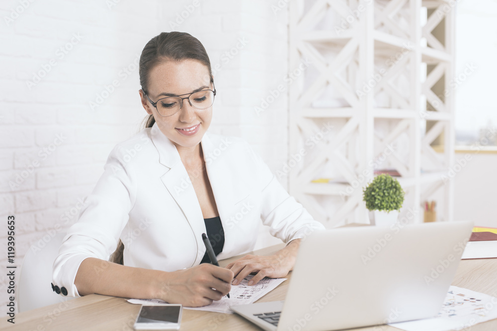 Smiling businesswoman doing paperwork Smiling businesswoman doing paperwork
